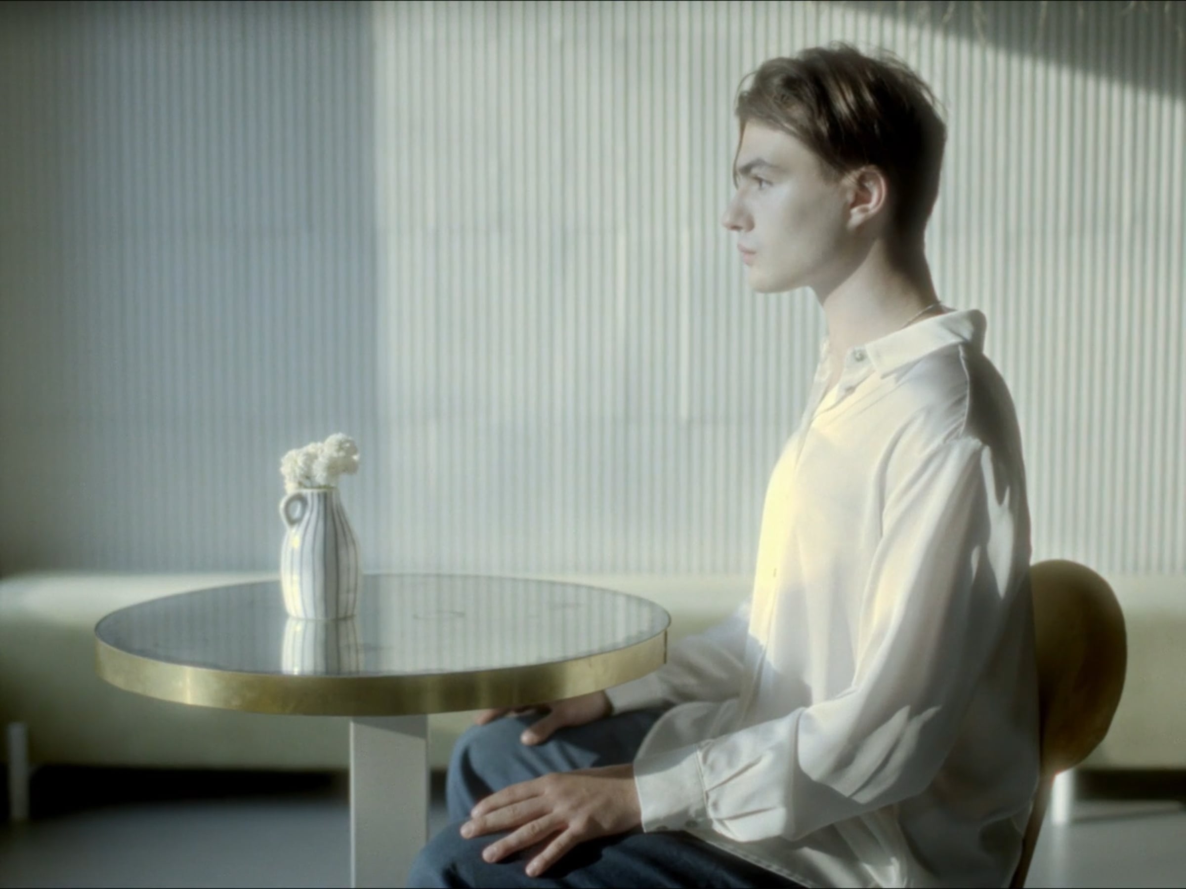 Mihai Cristescu seated in the pale, dreamlike world of The Humming Song